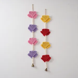 Bohemian woven wall hanging with wooden beads and tassels, handmade Nordic room decor detail.