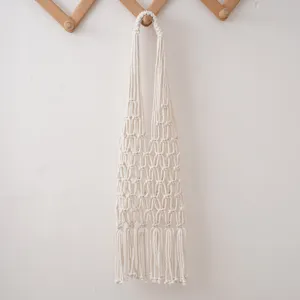 Handmade macrame cotton rope shopping bag detail, durable mesh fruit storage net hanging.