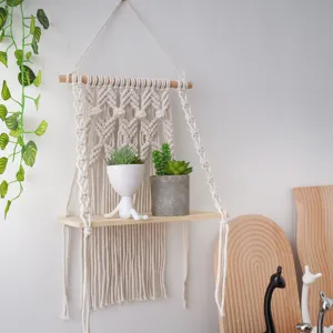 Bohemian handmade macrame wall hanging shelf with wooden board for chic home decor.