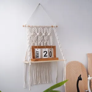 Close-up detail of bohemian woven wall tapestry shelf with wooden board for home decor.