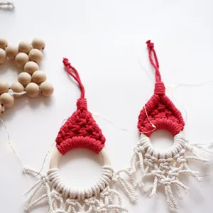 Handmade macrame Christmas tree hanging ornament gnome Santa hat with wooden ring for holiday decor.