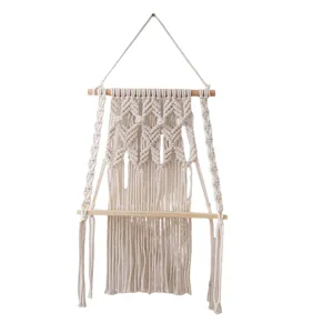 Boho handmade cotton macrame wall hanging shelf with wooden board for home decor storage.