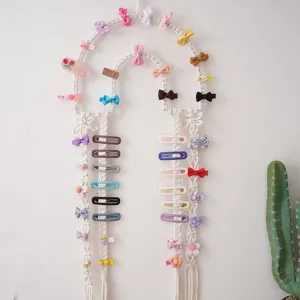 Bohemian handmade woven hairpin storage wall hanging, detailed view of cute children hair clips.
