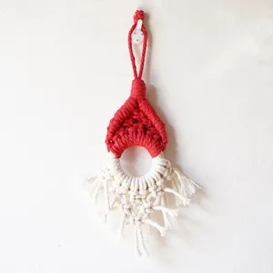 Handmade macrame Christmas gnome hanging ornament detail, red white cotton cord wall decor.