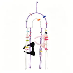 Handmade macrame hair clip organizer wall hanging, bohemian cotton bow and headband storage rack.