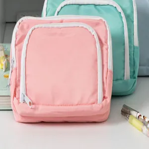 Detailed shot showing the front zipper pocket and fabric texture of the minimalist student pencil case.