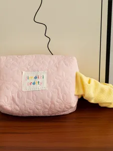 Pink quilted cosmetic bag large capacity makeup storage pouch for daily travel use.