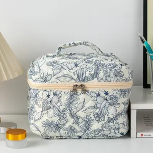 Trousse de maquillage matelassée à motif floral bleu, pochette de rangement portable chic.