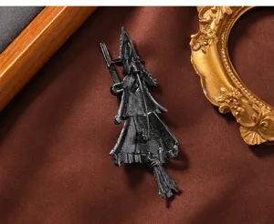 Vintage black witch brooch pin featuring a detailed broomstick design for Halloween wear.