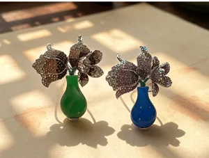 Detailed closeup of exquisite full rhinestone vase tulip brooch, elegant luxury metal flower pin.