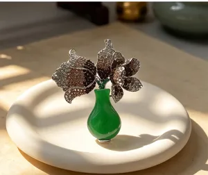Close-up of crystal full pavé tulip brooch in vase shape, sparkling rhinestone jewelry detail.