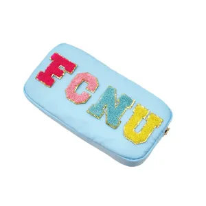 Light blue nylon cosmetic bag with colorful chenille letter patches FCNU, large capacity travel.