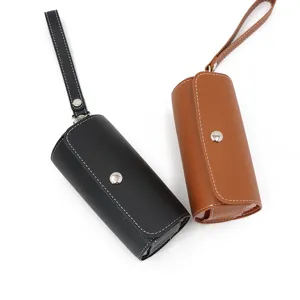 Portable PU leather 14-compartment weekly pill organizer box with strap in black and brown colors.