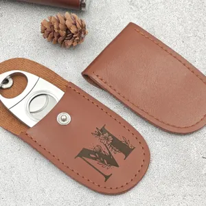 Brown PU leather cigar cutter sleeve with stainless steel cutter and floral letter M design.