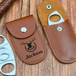Close-up of custom PU leather cigar cutter case with stainless steel blade and laser engraving.