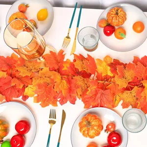 Detailed view of autumn artificial maple leaf garland on a festive dining table