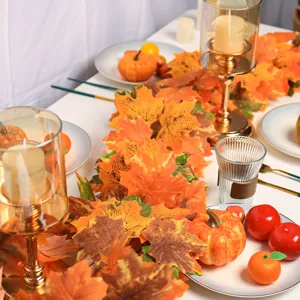 Detailed view of vibrant orange autumn maple leaf garland for festive table decor