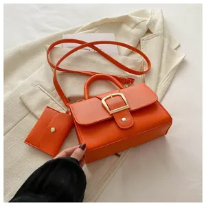 Schicke orangefarbene Umhängetasche mit passender Tasche und goldener Schnalle
