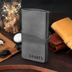PU leather cable organizer roll bag for travel, portable charger and earphone storage detail.
