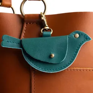 Teal leather bird shaped mini coin purse keychain close up detail view of accessory