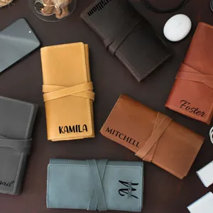 Detailed shot of retro PU leather roll-up organizer bag with personalized custom name engraving.