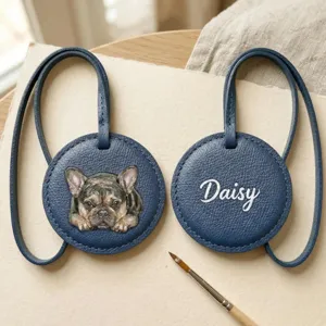 Hand-painted French bulldog leather bag charm close-up, custom name Daisy detail view.