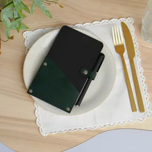 Black PU leather bill folder with green pocket and pen, stylish restaurant menu holder detail.