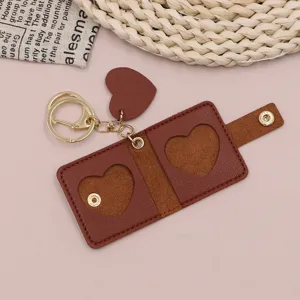 Detailed view of the brown leather photo keychain with heart design, compact and portable.