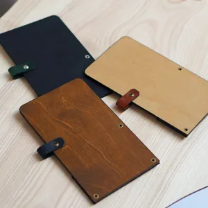 Wooden restaurant bill folder detail showing durable wood panel and PU leather strap fastener.