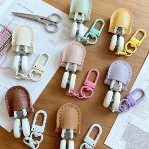 Closeup of colorful mini scissors with leather protective cases, ideal for embroidery craft.