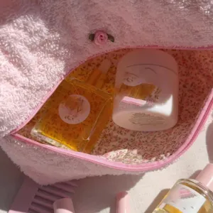 Pink towel fabric cosmetic bag with floral lining, portable toiletry pouch for travel.