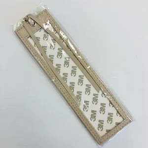 Beige PU leather bookmark sleeve protector with adhesive backing and metal hanging loop.