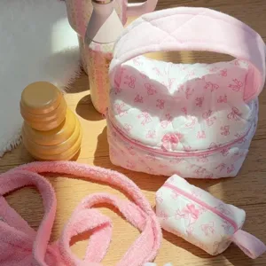 Pink quilted bow cosmetic bag set, soft towel fabric toiletry pouch for daily travel.