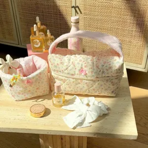 Detailed view of the cute floral quilted cosmetic bag with soft towel handle for daily storage.