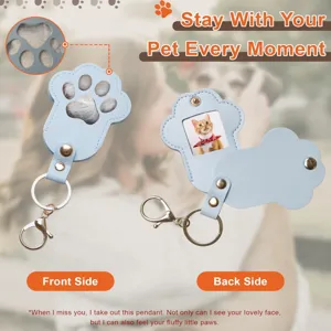 Close-up detail of the cute paw print PU leather pet memorial keychain with photo slot.