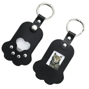 Portable cat paw PU leather keychain with pet hair storage pocket and photo frame design.