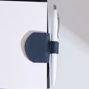 PU leather magnetic bookmark pen holder clip, dual-use stationery school accessory.