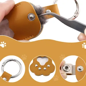 Detailed view of cute cat paw PU leather pet hair storage keychain metal clasp accessory