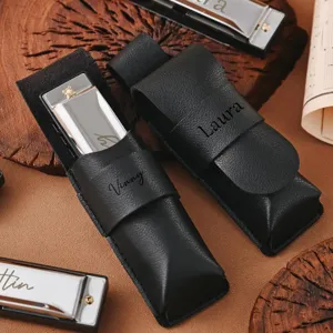Portable PU leather harmonica protective case with custom engraved name design for musicians.