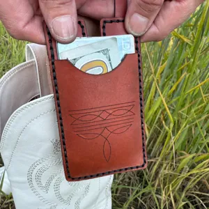 Detalle de cartera de bota de cuero marrón hecha a mano con ranura para tarjetas.