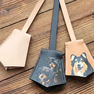 Hand-painted leather pet luggage tag detail showing fine stitching and vivid dog artwork.