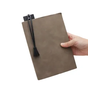 Close-up detail of the PU leather notebook cover with elegant black tassel bookmark strap.