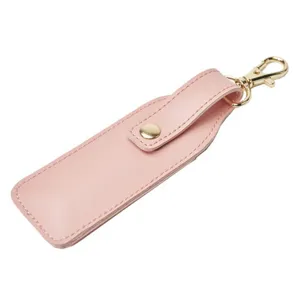 Pink PU leather lipstick case detail view, portable lip balm storage bag keychain accessory.