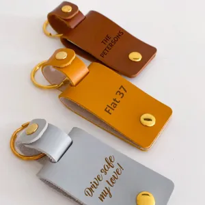 Custom PU leather keychain with metal ring and personalized laser engraved text for gifts.