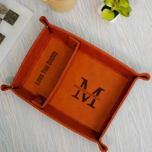 Orange PU leather valet tray with compartments and custom text for desktop organization detail.