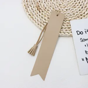 Close-up of khaki PU leather tassel bookmark, stylish stationery accessory detail.