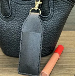 PU leather lipstick sleeve detail, portable makeup storage bag with keychain hook for handbag.