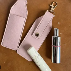 Pink PU leather lipstick holder keychain set with cute character design and portable case.