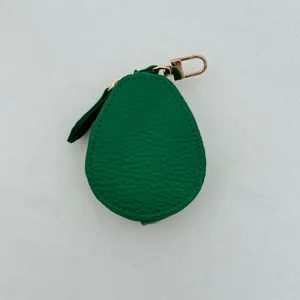 Detailed close-up of green avocado PU leather coin purse with gold keychain hook and leaf accent.