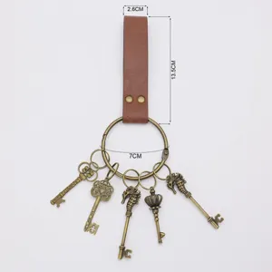 Detail view of medieval PU leather keychain with vintage bronze rings and decorative skeleton keys.